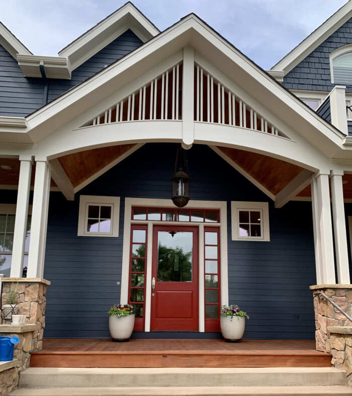 Black Shingle Siding With a Bold Red Front Door