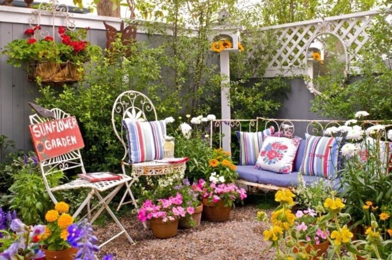 Front yard with repurposed planters and flowers.