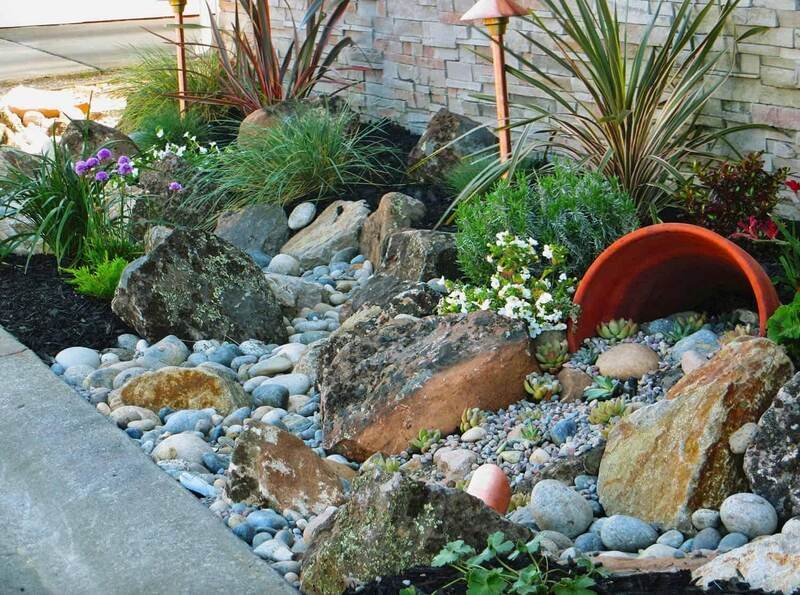 Rock garden with stones and plants for a calming front yard.