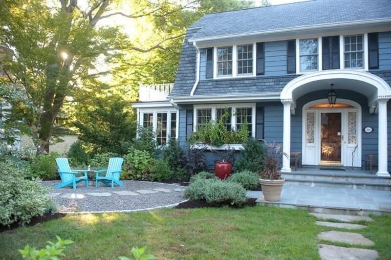 Cozy outdoor seating area with chairs, plants, and lights