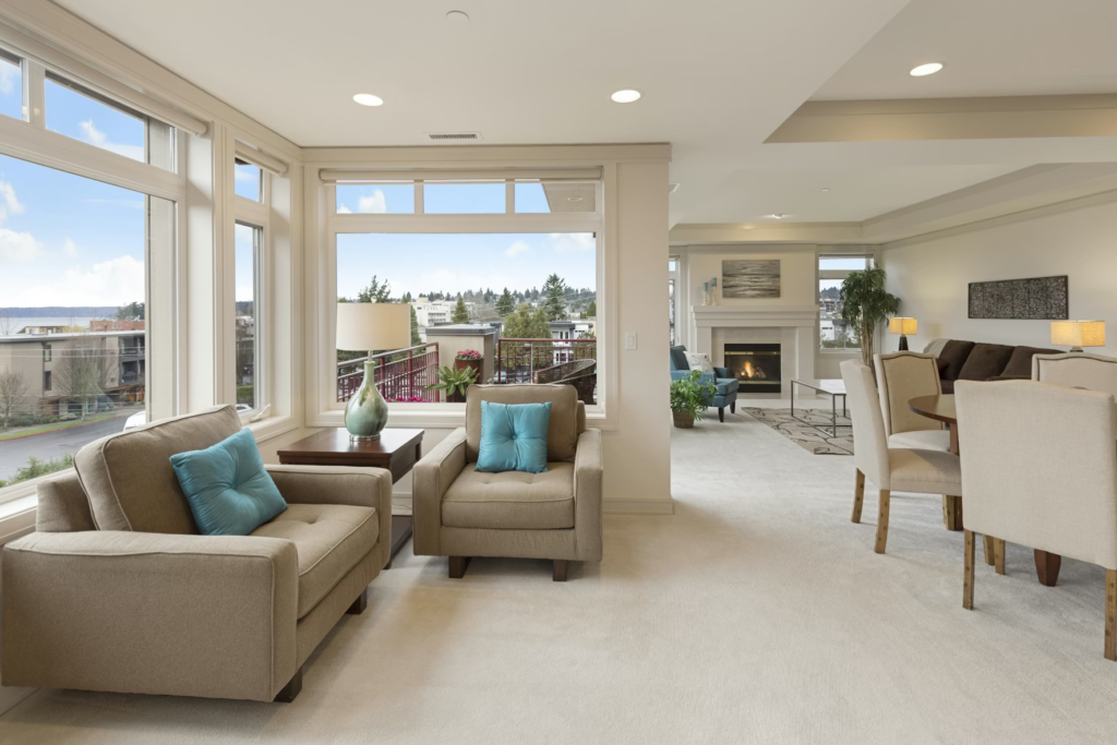 Why This Year Is the Perfect Time to Upgrade Your Windows A spacious living room featuring large windows and a cozy dining area, filled with natural light.