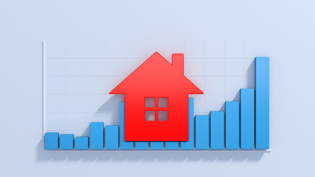 Red house icon overlays a blue bar graph with ascending bars on a grid background, symbolizing growth in real estate or housing market trends.